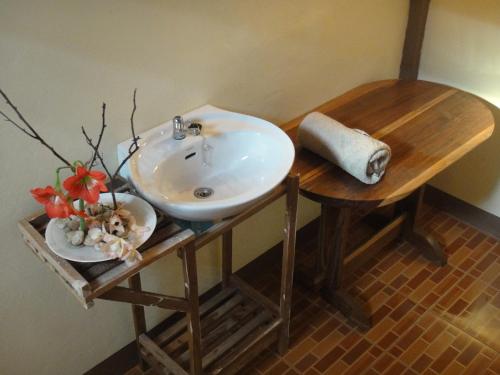 a bathroom with a sink on a wooden table at Sangsawang Resort in Mae Hong Son