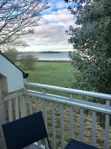 a bench on a white fence with a view of the water at Normanton Park Hotel, Sure Hotel Collection by Best Western in Oakham