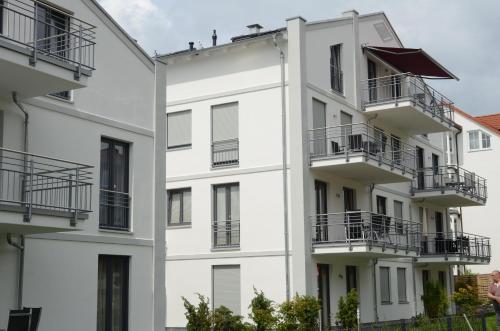 an external view of a white building with balconies at Residenz Margarete - Apt. 2.3 in Binz