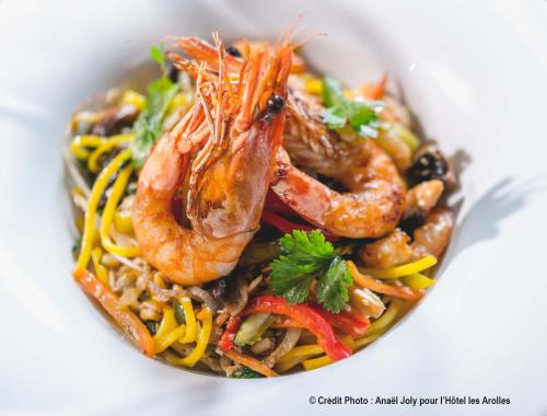 a bowl of food with shrimp and noodles at Hotel Les Arolles in Méribel