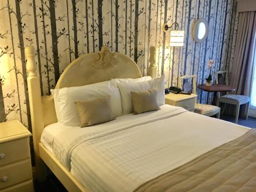 a bedroom with a large bed with a white bedspread at Normanton Park Hotel, Sure Hotel Collection by Best Western in Oakham