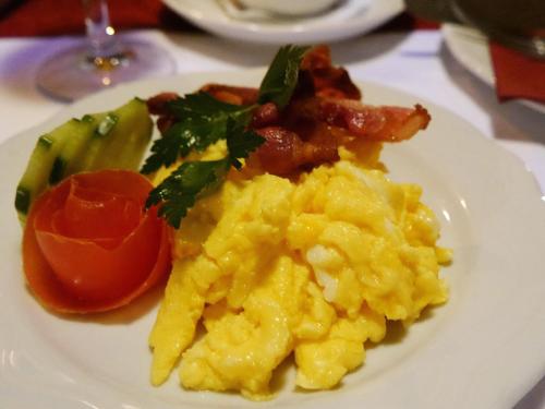 a plate of scrambled eggs and vegetables on a table at Oma's Küche & Quartier in Binz