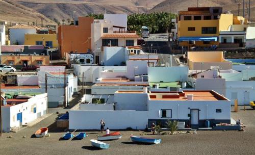 a group of buildings with boats on the beach at Casa Pano Beach House in Ajuy
