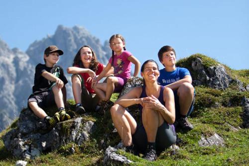 a group of people sitting on top of a mountain at Ferienwohnung Biechl-Hauser Doris in Sankt Ulrich am Pillersee