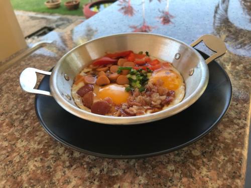 a pan of food with eggs and vegetables on a counter at Sleep Soundly By The Sea in Trat