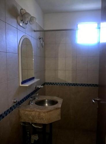 a bathroom with a sink and a mirror at Cabanas Valle Azul in Villa Rumipal