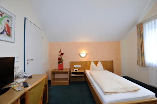 Tempat tidur dalam kamar di Hotel Apollo Garni