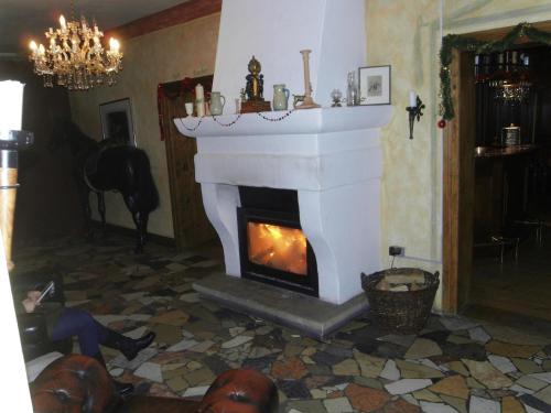 a fireplace in a living room with a person laying on the floor at Posthotel Sachrang in Sachrang
