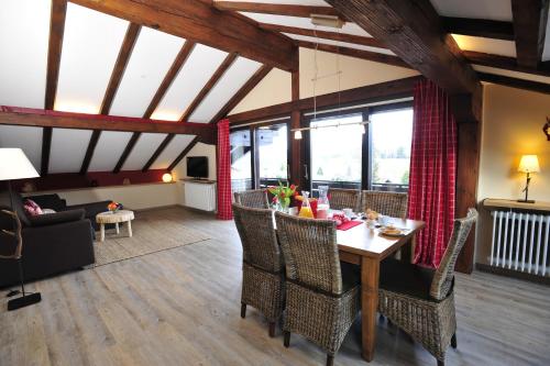 a dining room with a table and chairs in a room at Auszeit in Obermaiselstein