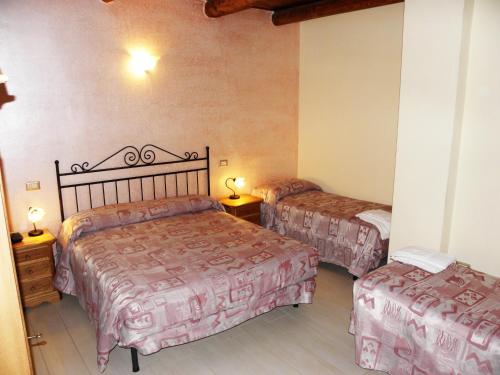 a bedroom with two beds and two ottomans at Agriturismo La Colombaia in Capua