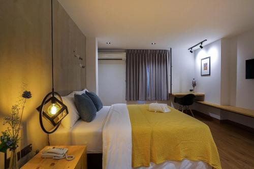 バンコクにあるHap@sathornのベッドルーム1室(大型ベッド1台、黄色い毛布付)