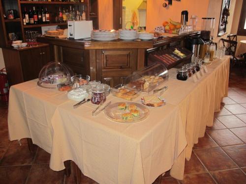 a row of tables with plates of food on them at Hotel Kroupi in Elati Trikalon