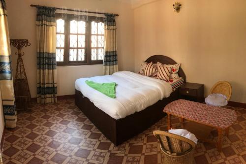 a small bedroom with a bed and a window at SUBI Home Stay in Kathmandu