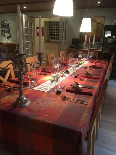 a long table with wine glasses on top of it at Best Bed in Herning