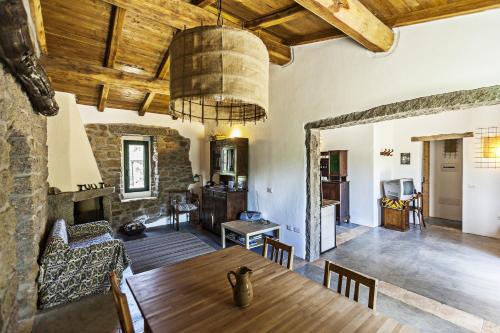 a living room with a wooden table and a dining room at Stazzo La Casedda in Luogosanto
