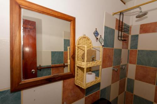 a bathroom with a mirror and a sink at Tuzco Lodge in Puerto López