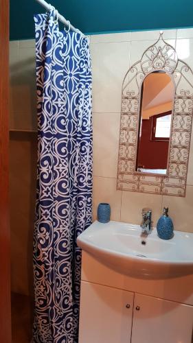 a bathroom with a sink and a shower curtain at Studio Maison 3 Kapana in Plovdiv