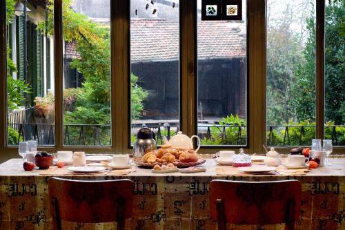 a table with a bunch of food on it at Il Cortile - Casa d'Artista in Casalzuigno