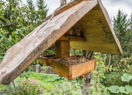 a wooden bird house with a nesting box at Farm Stay Žagar in Mozirje