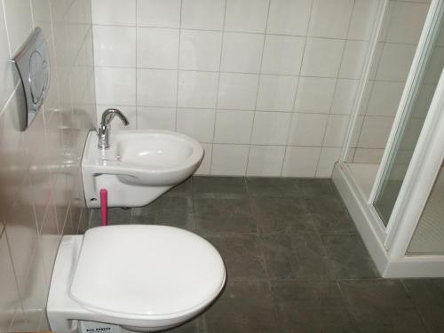 a bathroom with a toilet and a sink at Tenuta Tredici Ulivi in Senigallia