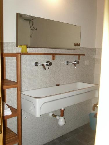 a bathroom with a white sink and a mirror at Tenuta Tredici Ulivi in Senigallia