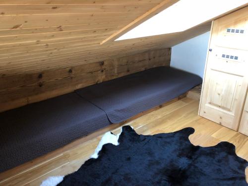 Bett in einem Zimmer mit Holzdecke in der Unterkunft Studio 166 Le Bristol Villars in Villars-sur-Ollon