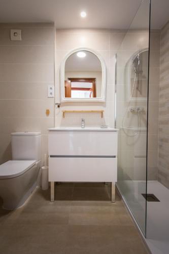a bathroom with a sink and a toilet and a mirror at Holidays2Riviera Sea Side Front Beach in Mijas Costa