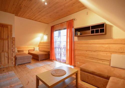 a living room with a couch and a table at Siedlisko Białogóra in Białogóra