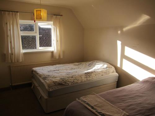 a bedroom with two beds and a window at No 9 in Bognor Regis