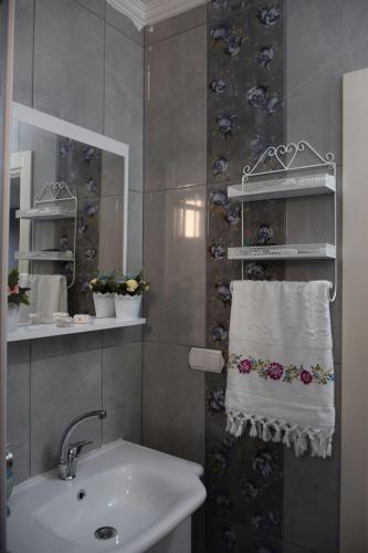 a bathroom with a sink and a white towel at Trabzon Sea Palace in Trabzon