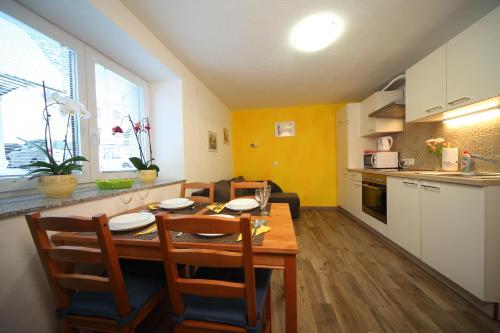 a kitchen and dining room with a table and chairs at Danijela & Gregor in Rateče