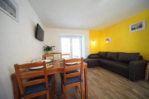 a living room with a table and a couch at Danijela & Gregor in Rateče