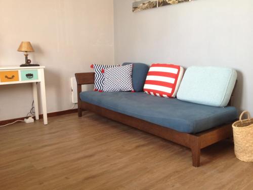 a blue couch with pillows on it in a living room at Casa de Mar @ Porto Côvo in Porto Covo