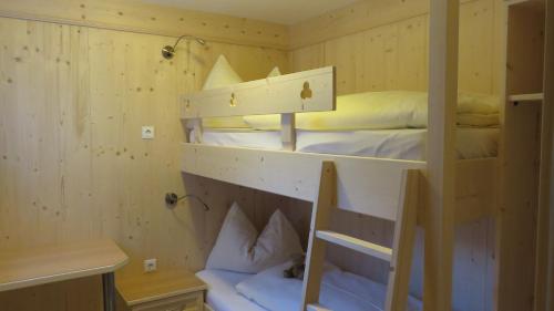 Pokój z 2 łóżkami piętrowymi i krzesłem w obiekcie Appartement Elena w mieście Umhausen