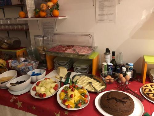 a table topped with plates of food on a table at Hotel Villa Enea in Cattolica