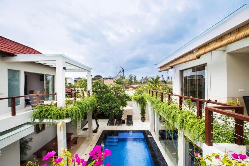 an external view of a house with a swimming pool on a balcony at Sunset Paradise Jimbaran 3003 in Jimbaran