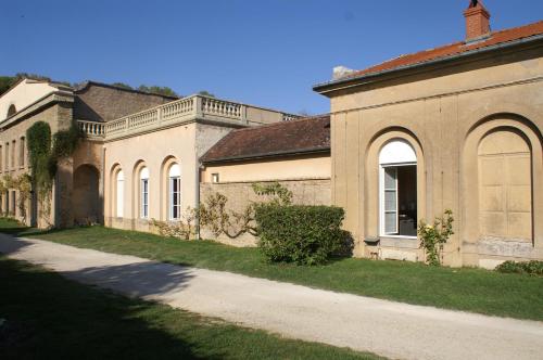 a large brick building with a road in front of it at B&B Vassy Etaule in Avallon