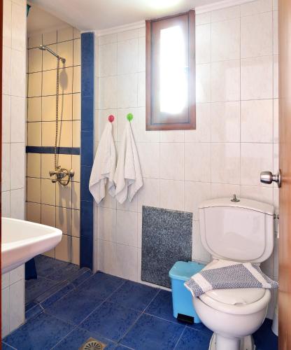 a bathroom with a toilet and a sink at San Antonio Apartments in Kolymvari