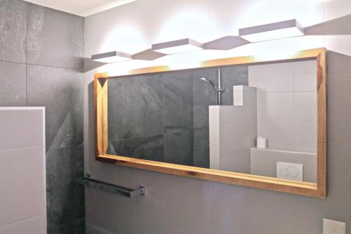 a bathroom with a mirror and a shower at Au centre d'Ovronnaz - Chalet mitoyen in Ovronnaz