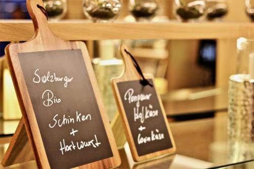a couple of signs sitting on a counter in a store at Landhotel Laudersbach in Altenmarkt im Pongau