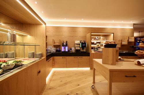 a large kitchen with wooden cabinets and a counter at Landhotel Laudersbach in Altenmarkt im Pongau