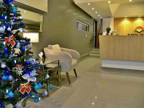 a christmas tree in the lobby of a hospital at Hotel Puesta del Sol by Nobile in Encarnación