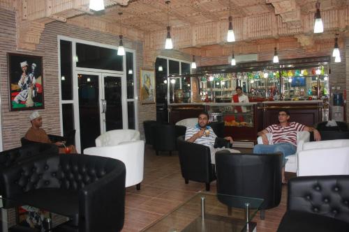 a group of people sitting in a bar at Bayan International Hotel in Mawāliḩ