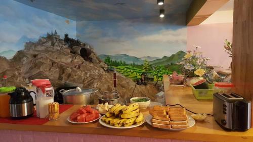 a counter with plates of bananas and other food at Sapa Scenery Hotel in Sa Pa