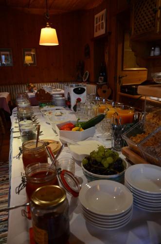 a long table with plates and bowls of food at Landgasthof Santner in Thalgau