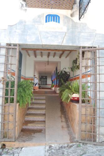 a stairway leading to a building with plants on it at La Casona Azul Boutique Hotel in Malinalco