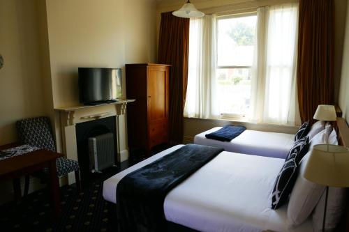 Postel nebo postele na pokoji v ubytování Highland House Boutique Hotel