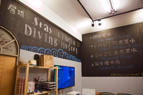 a black wall with writing on it in a room at Stay Liuqiu Diving Hostel in Xiaoliuqiu