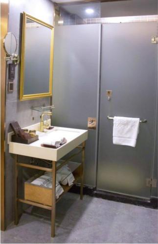 a bathroom with a sink and a shower at James Joyce Coffetel Beijing Gulou street, Nanluoguxiang in Beijing