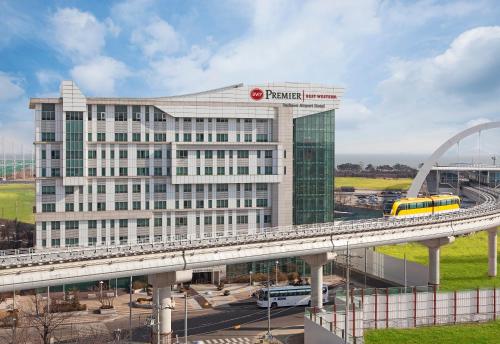 a large building with a train on a bridge at Best Western Premier Incheon Airport Hotel in Incheon